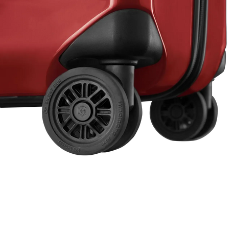 Wheels of a red suitcase or luggage.
