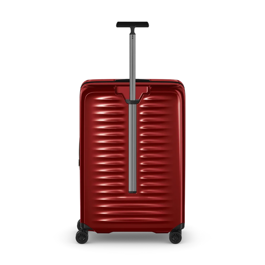Red hardshell rolling suitcase with horizontal ridges and an extendable handle.
