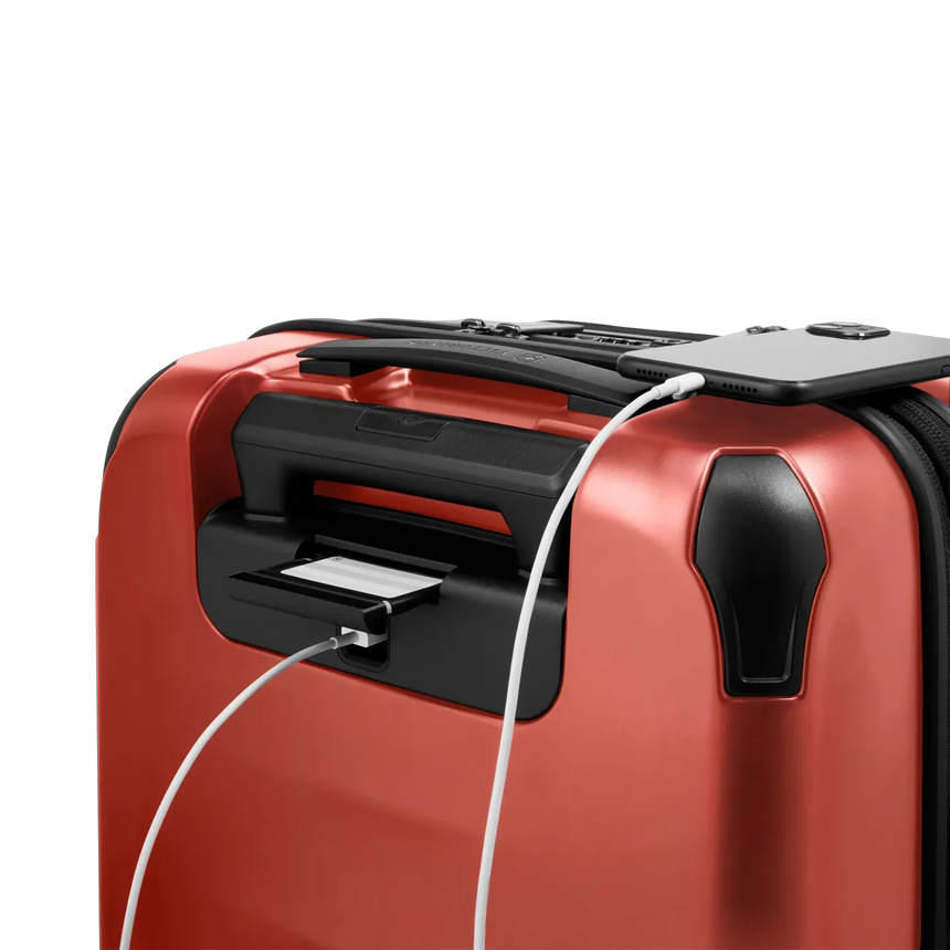 Red suitcase with a built-in USB charging port.