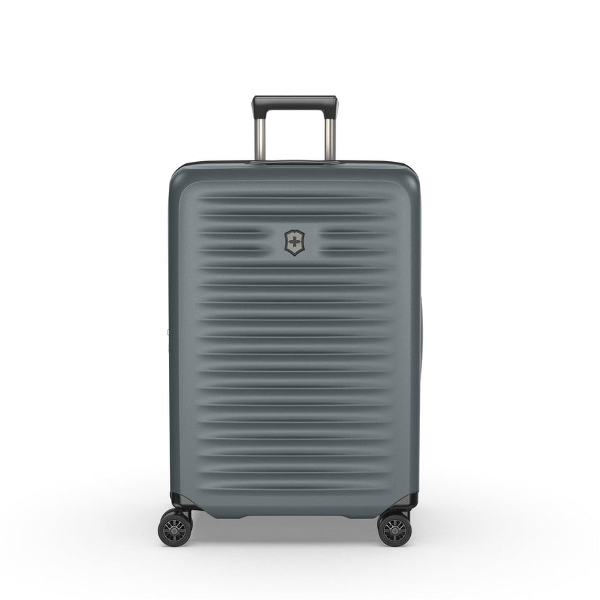 Gray hardshell rolling suitcase with horizontal ridges and a retractable handle.