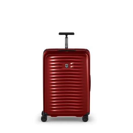 Red hardshell rolling suitcase with horizontal ridges and a retractable handle.