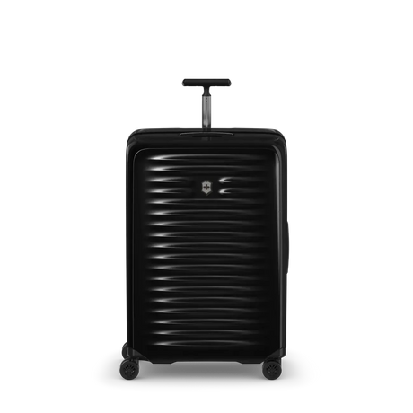 Black hardshell rolling suitcase with horizontal ribbed texture and extendable handle.