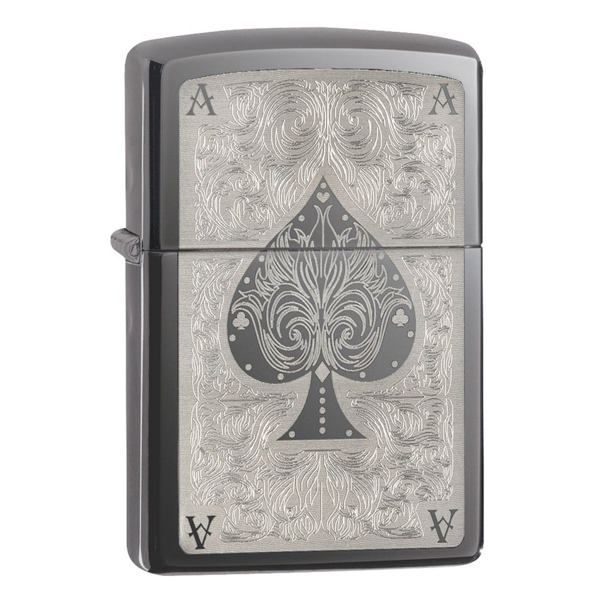 Zippo lighter with an ornate ace of spades design engraved on its surface.