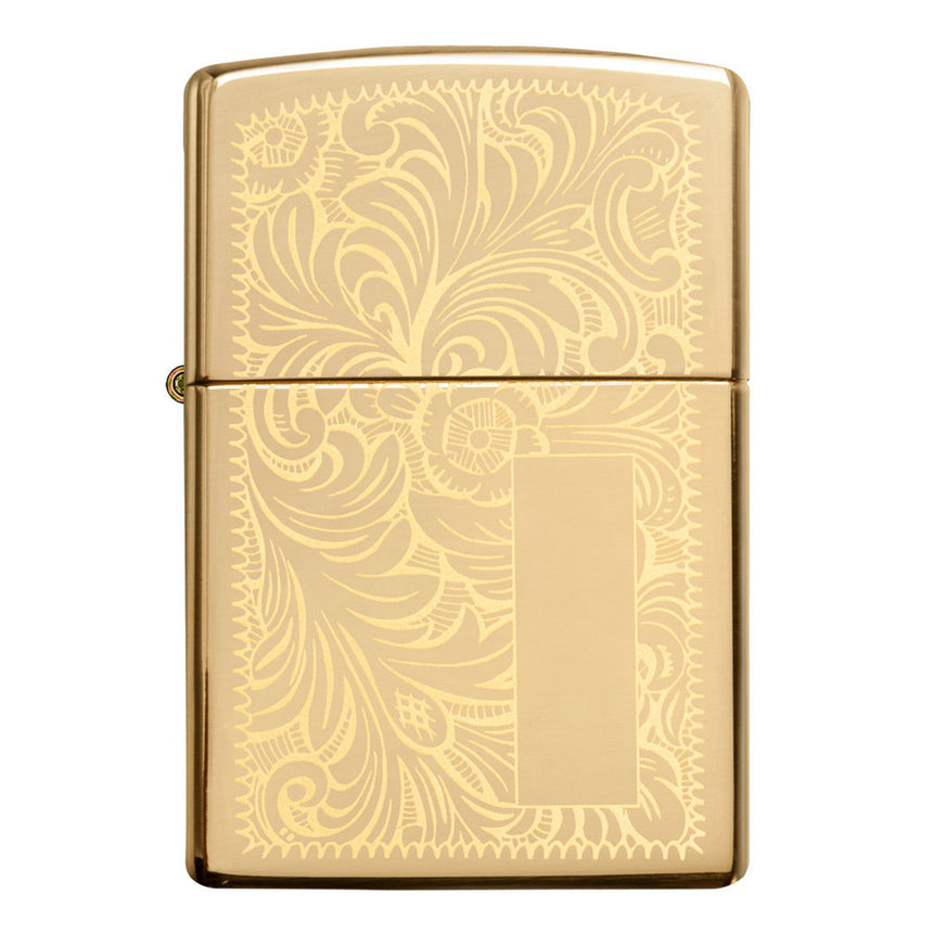 Gold-colored Zippo lighter with an ornate floral engraving pattern.
