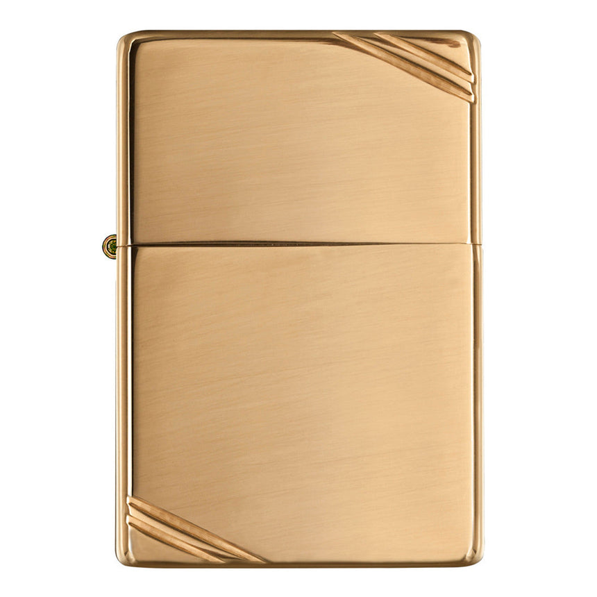 Gold-colored metal lighter with diagonal corner accents.
