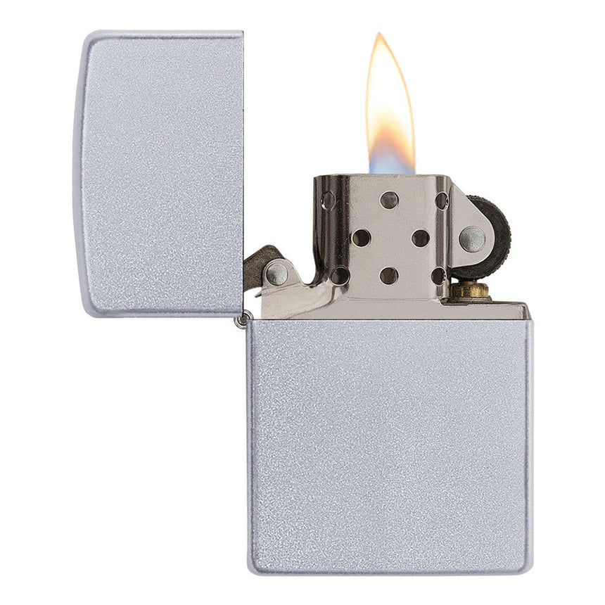 Lit silver metal lighter with an open lid and visible flame.
