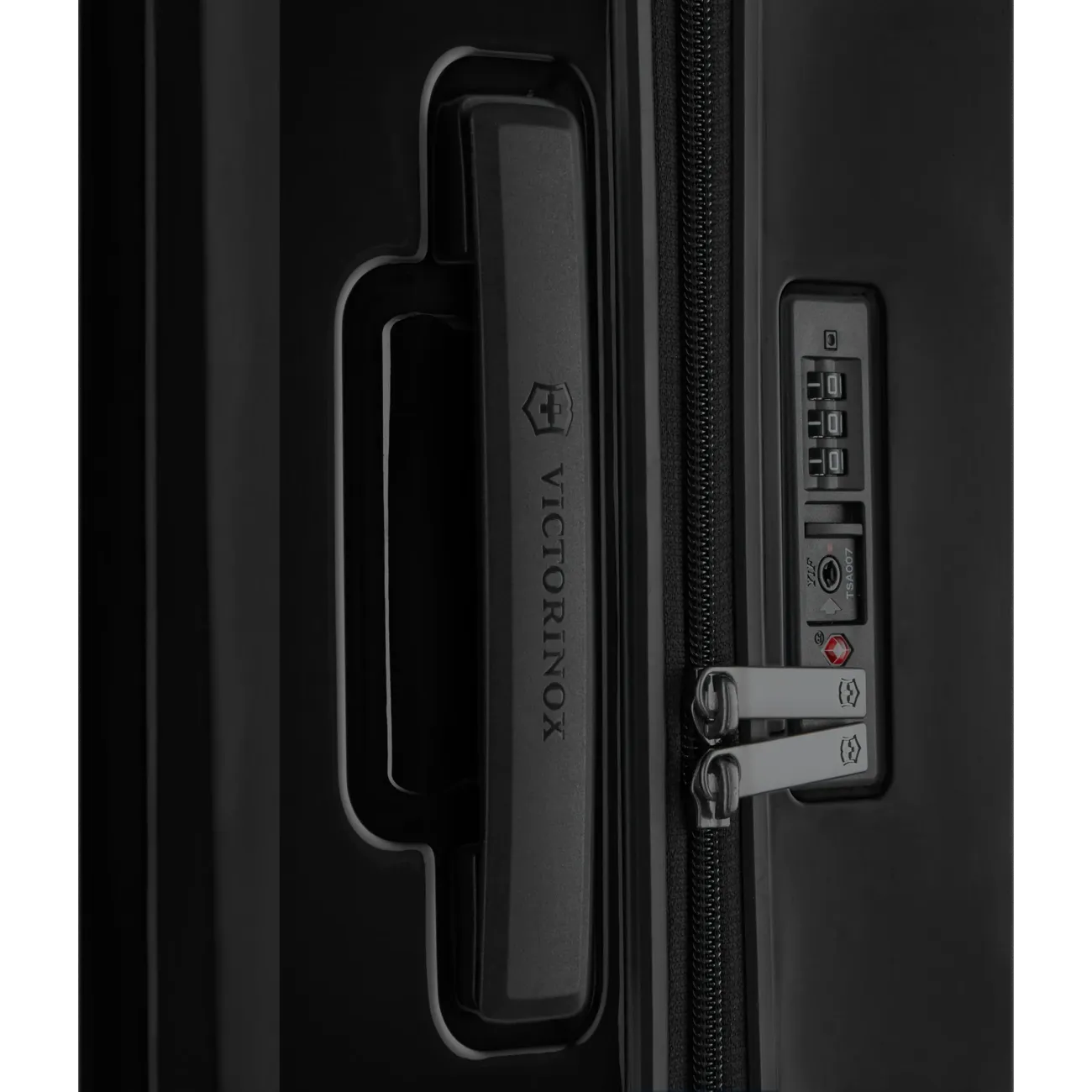 Luggage handle and combination lock on a black suitcase.