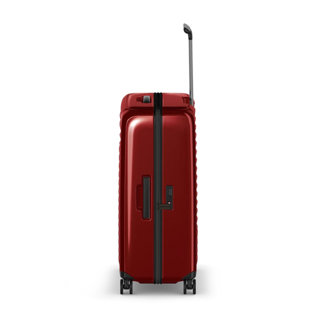 Red hardshell rolling suitcase with a telescoping handle and wheels.
