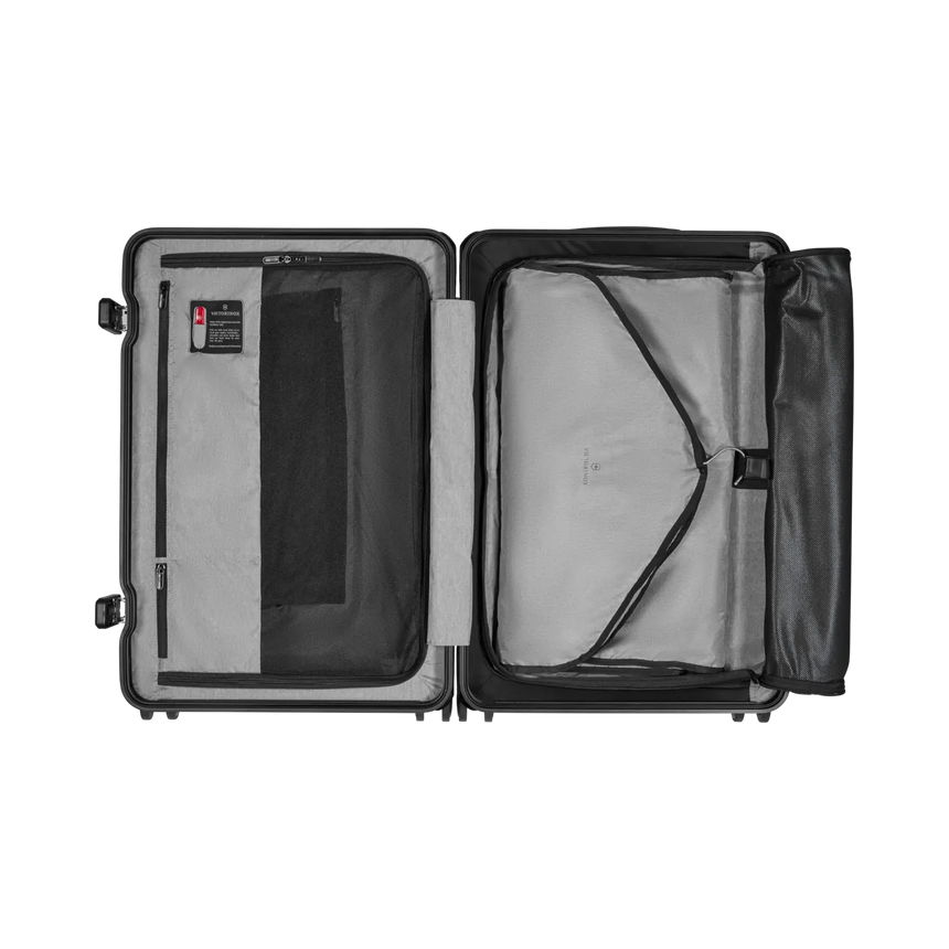 Open suitcase with compartments and straps for organizing contents.