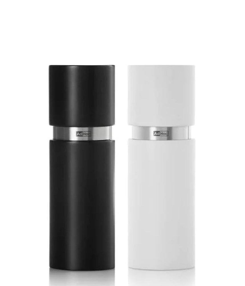 Pair of cylindrical salt and pepper grinders in black and white.