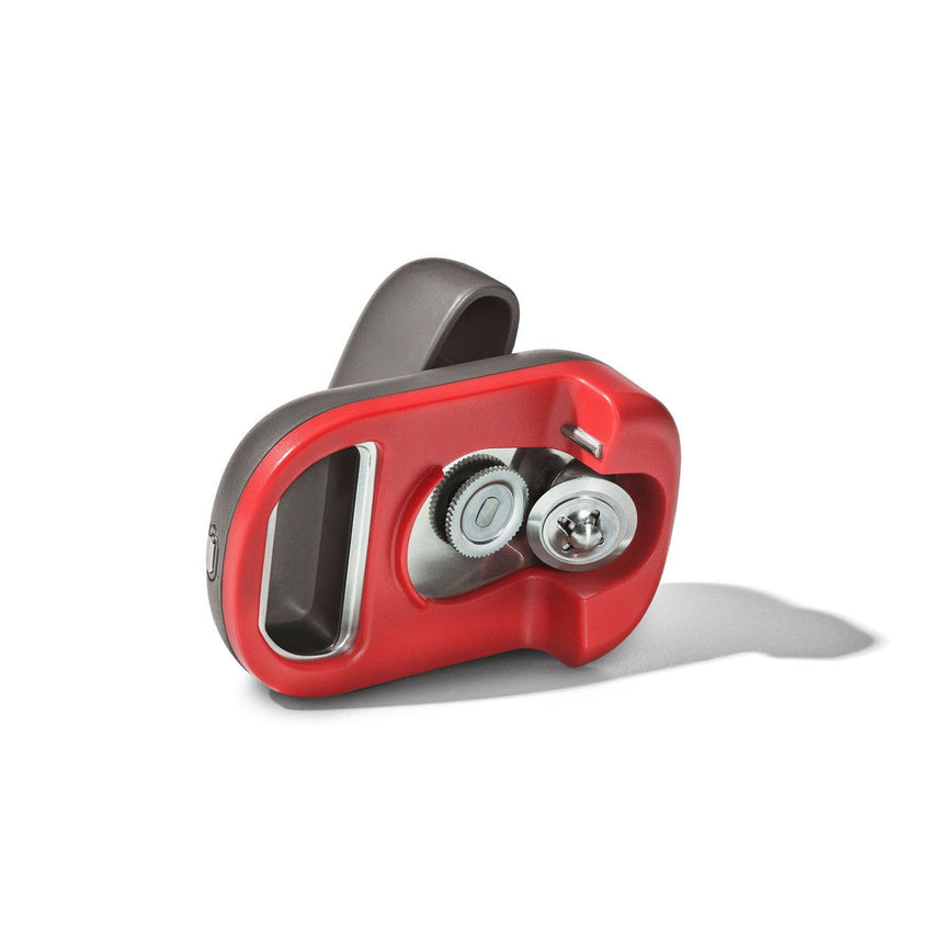 Red and gray handheld can opener with a curved handle and two cutting wheels.