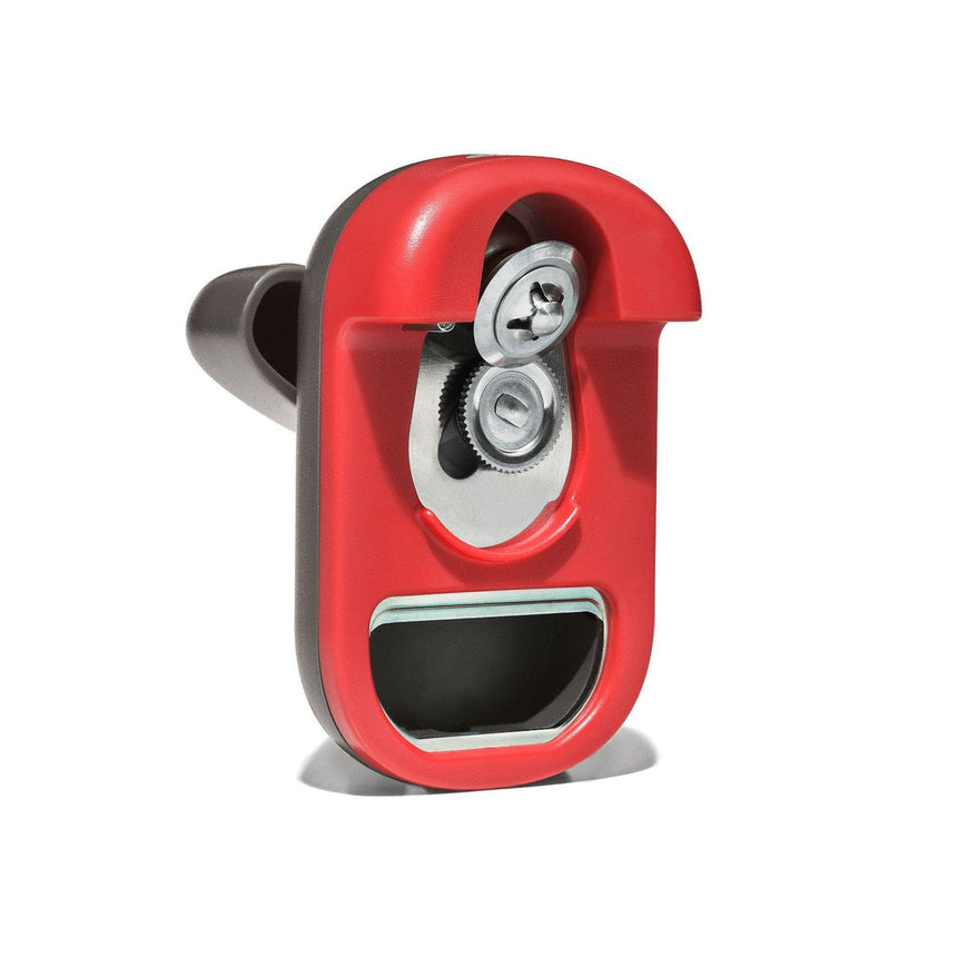 Red can opener with a metallic cutting wheel visible.