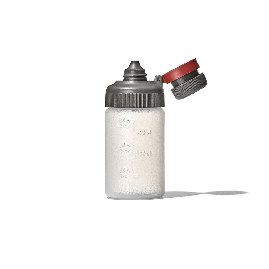 Plastic squeeze bottle with measurement markings and a gray cap with a red flip-top.