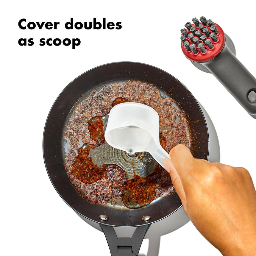 Frying pan containing cooked ground meat with a white utensil scooping some out.
