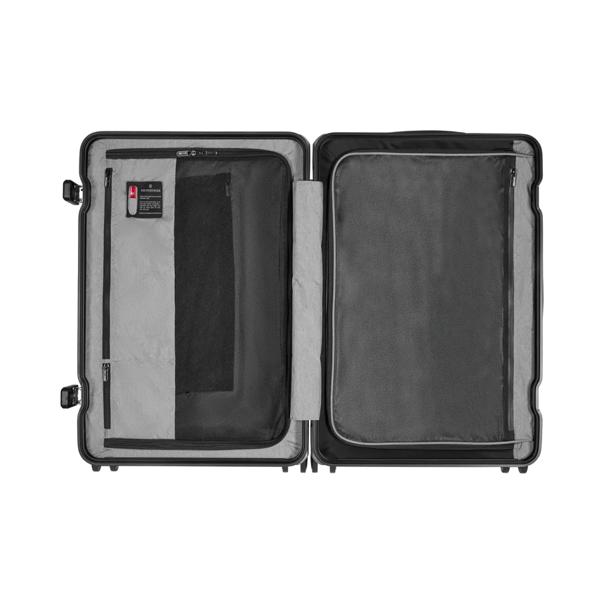 Open hard-shell suitcase with two compartments and interior pockets.