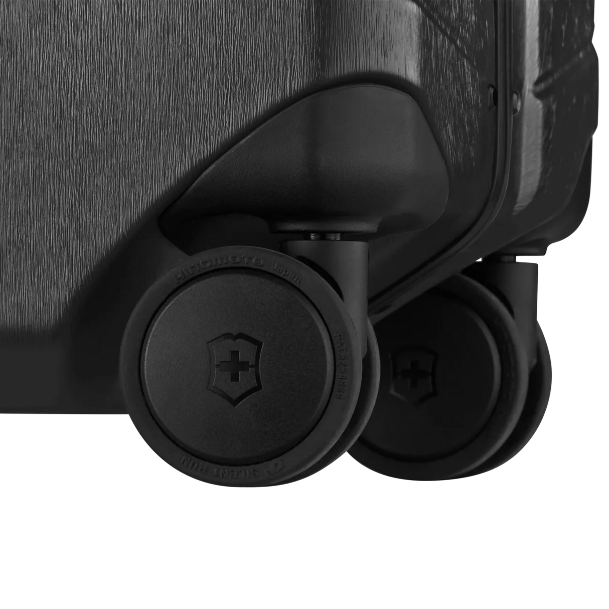 Luggage wheels attached to the bottom corner of a suitcase.
