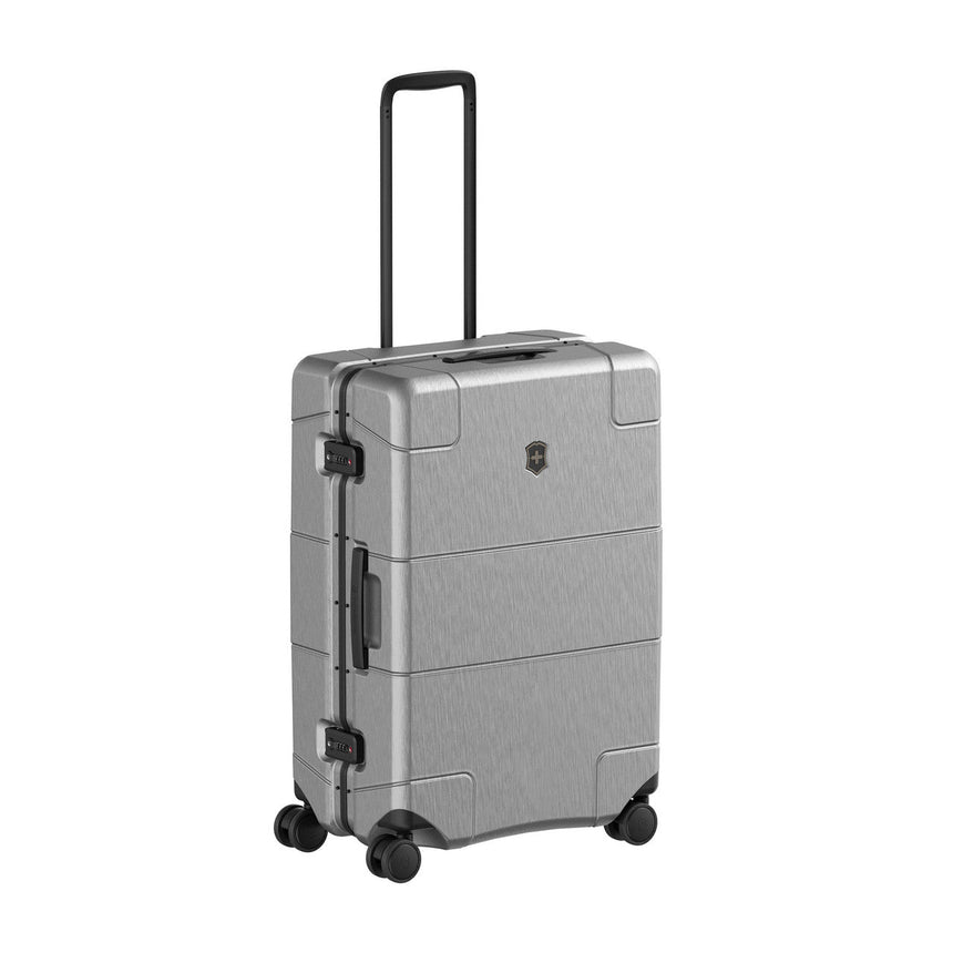 Silver hardshell rolling suitcase with a retractable handle and wheels.
