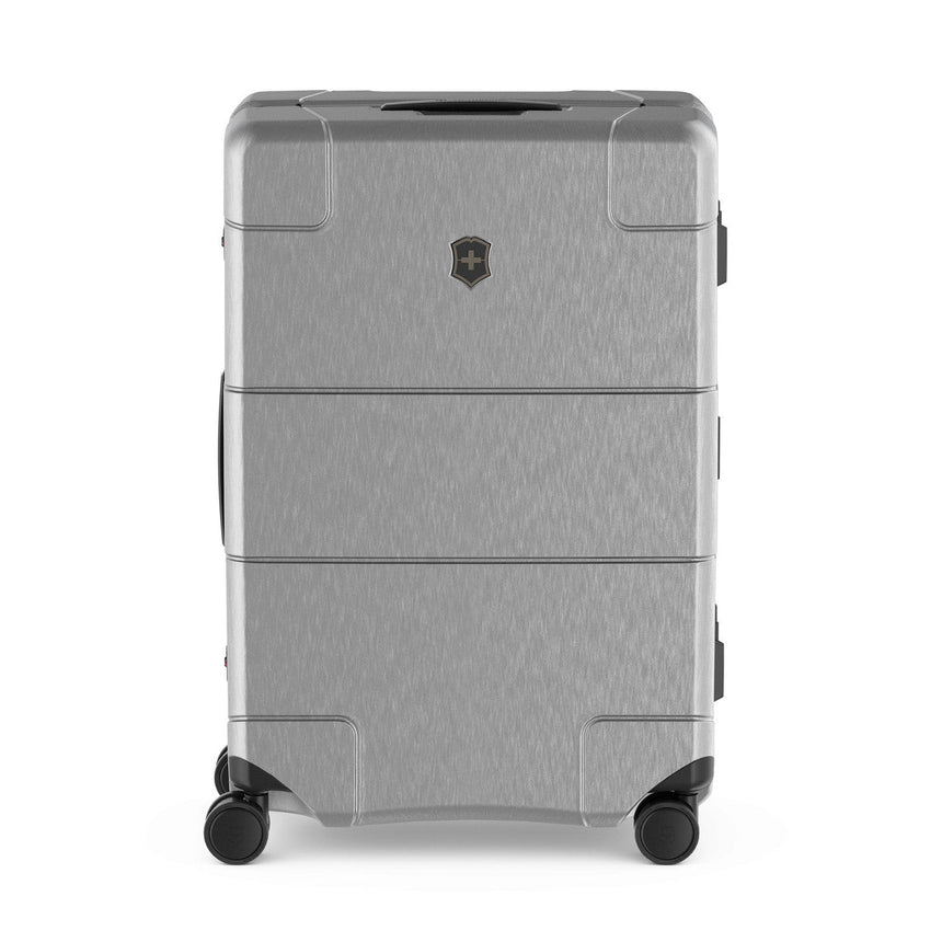 Gray hardshell rolling suitcase with multiple compartments and a logo emblem.