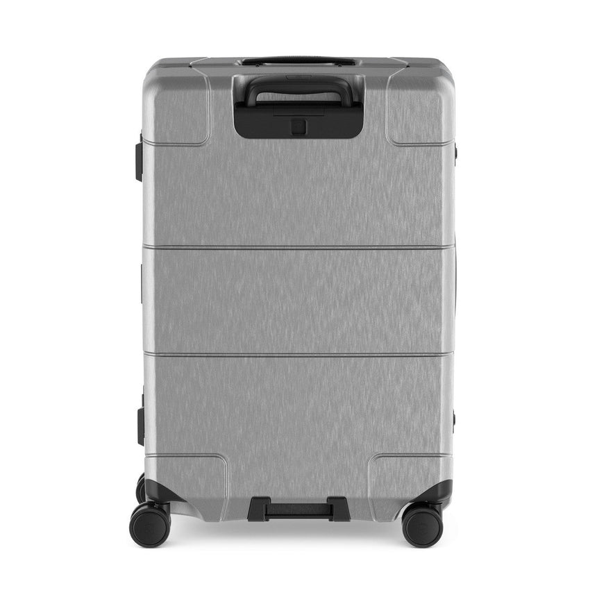 Silver hardshell rolling suitcase with multiple compartments and a retractable handle.