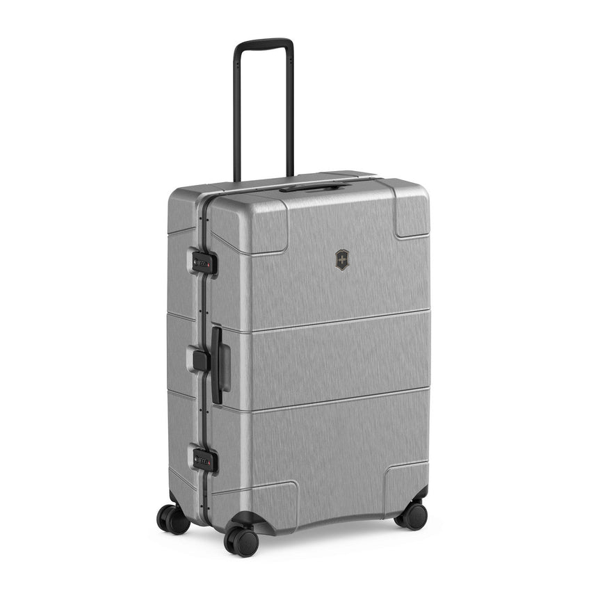 Silver hardshell suitcase with wheels and a retractable handle.