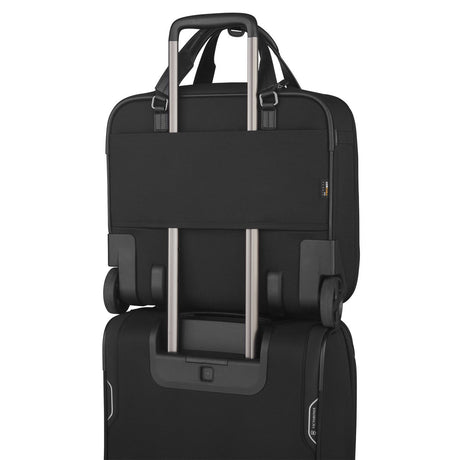 Black laptop bag with a luggage strap for attaching to rolling suitcases.