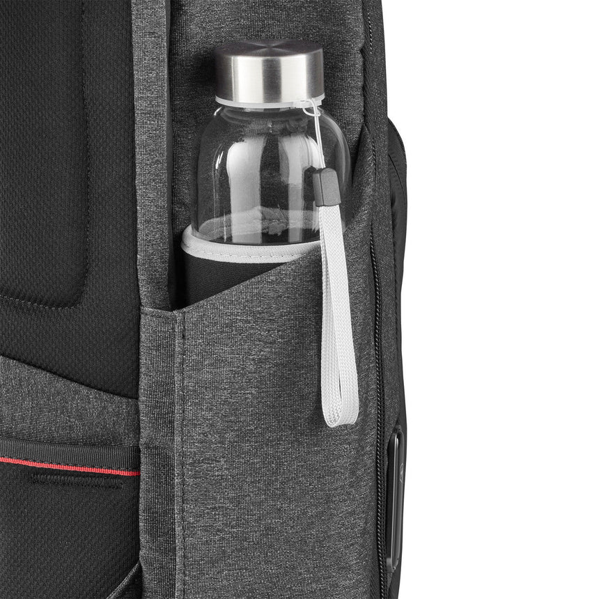 Glass water bottle with a white handle in a backpack’s side pocket.