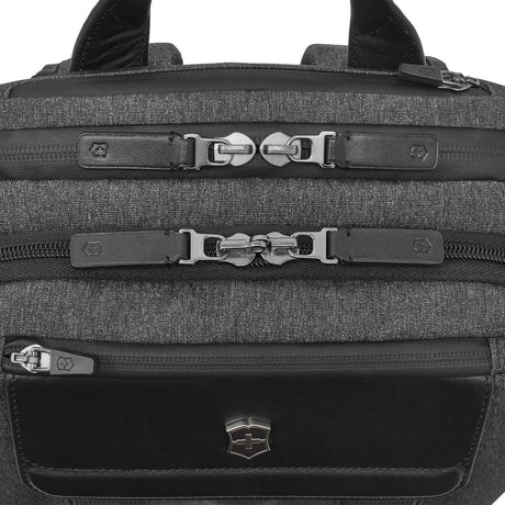 Backpack with multiple zippered compartments and buckle closures.