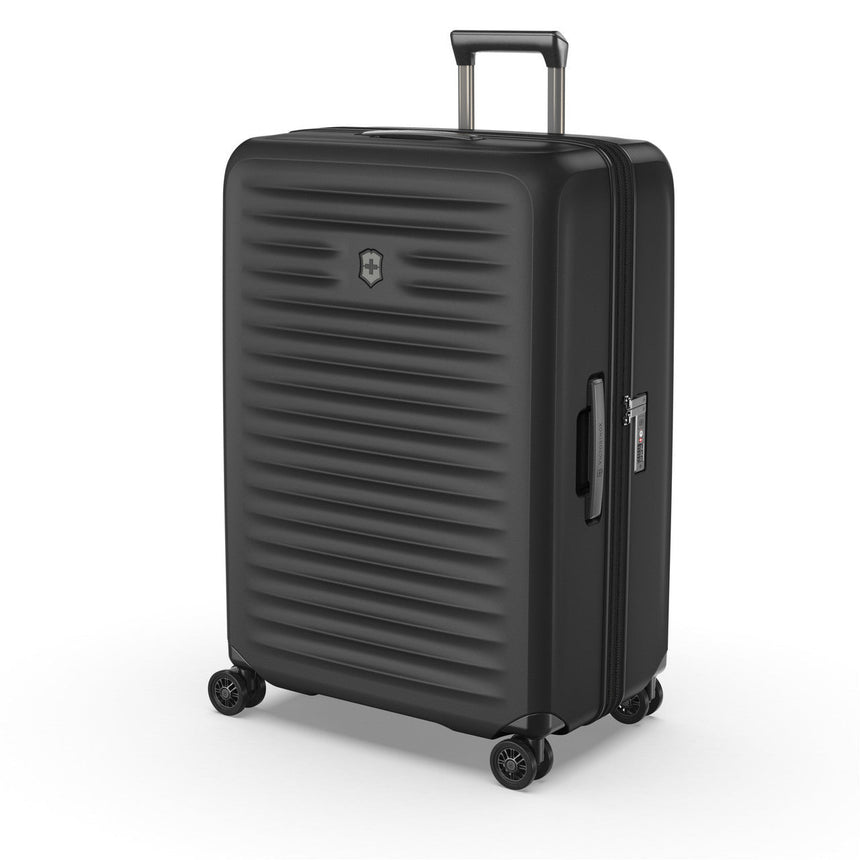 Black hardshell suitcase with horizontal ridges and wheels.
