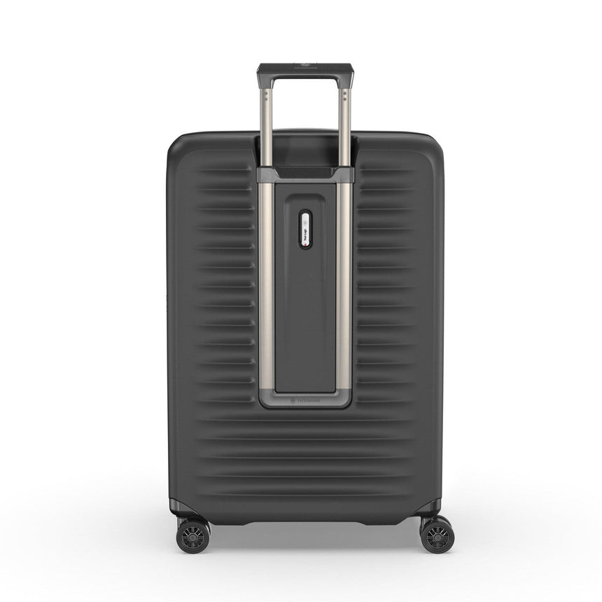 Dark gray hardshell suitcase with a retractable handle and wheels.