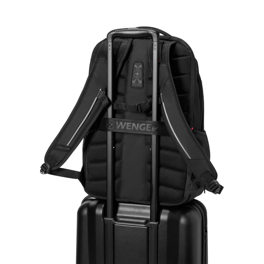 Black backpack with a luggage strap designed to fit over a suitcase handle.