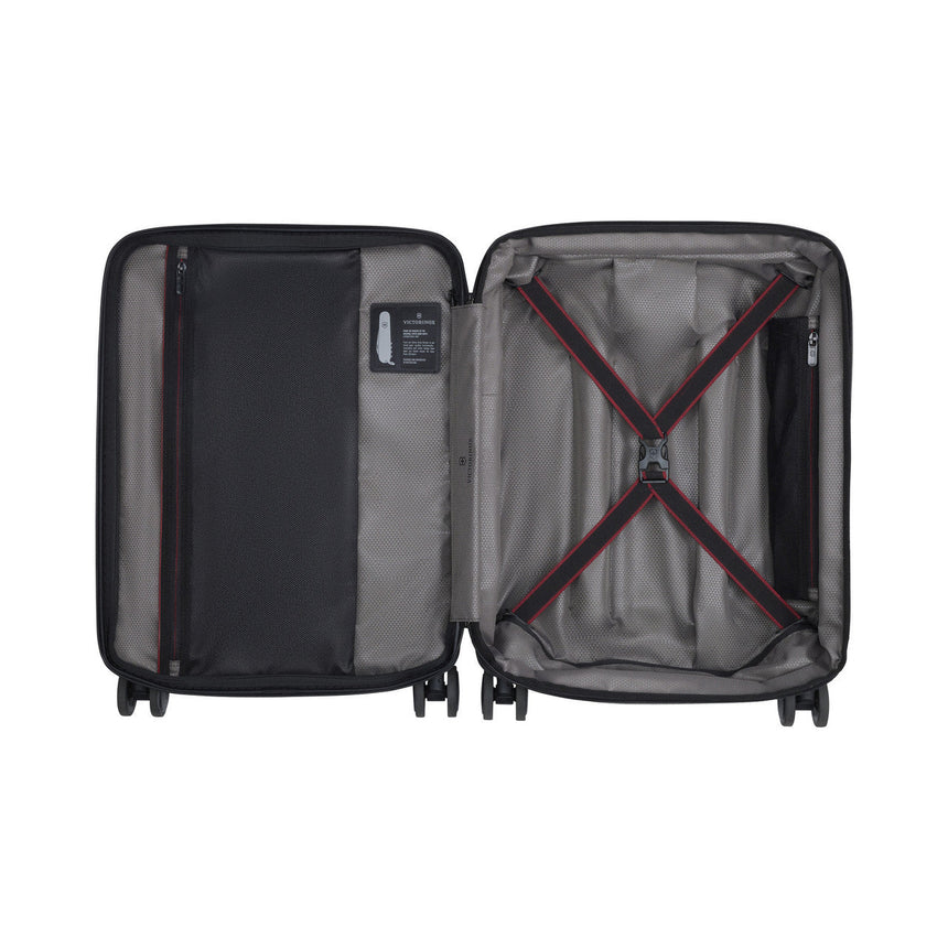 Open hard-shell suitcase with interior compartments and straps.