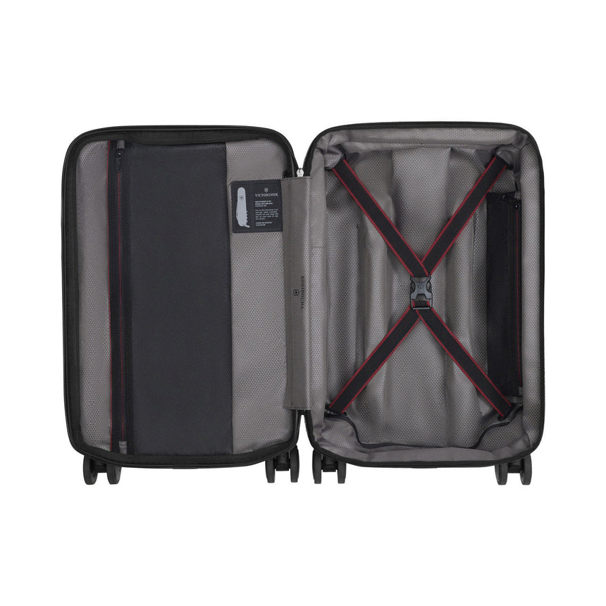 Open hard-shell suitcase with interior compartments and straps.