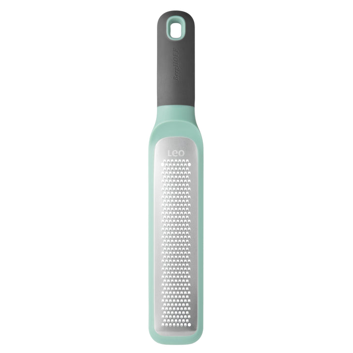 Mint green and gray kitchen grater with a long handle.