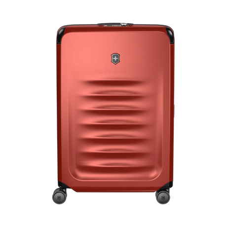 Red hardshell rolling suitcase with horizontal ridges and a logo emblem.
