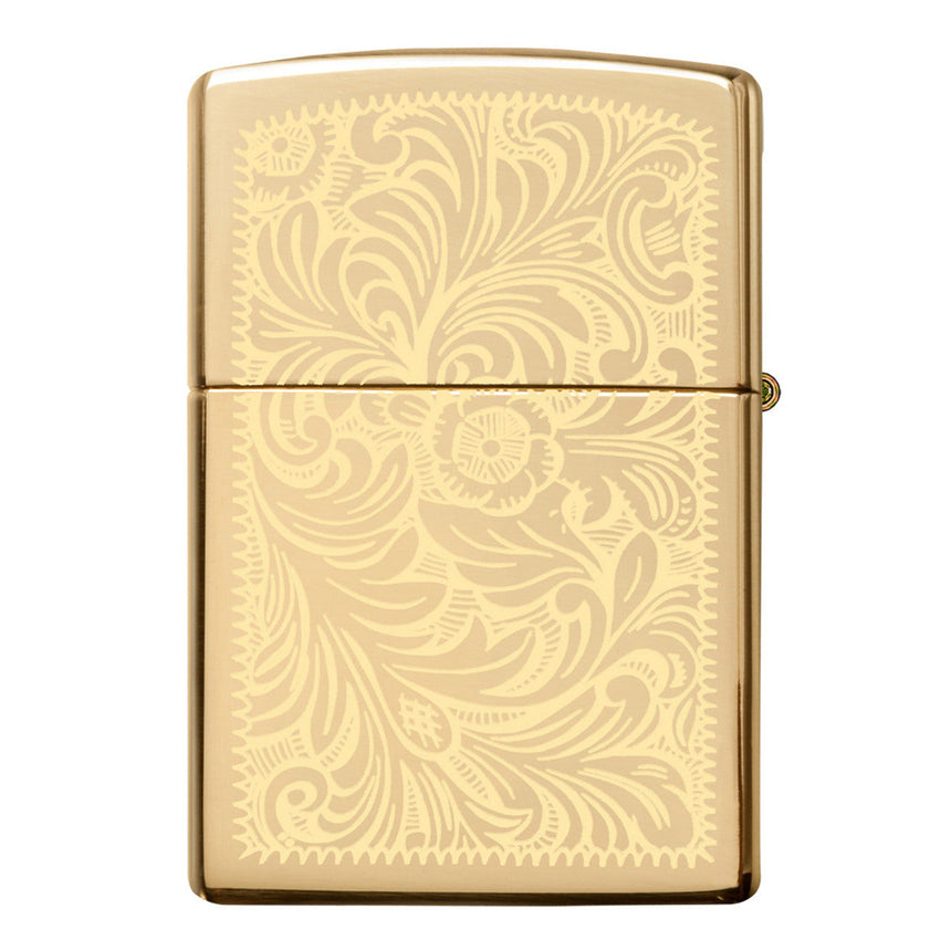 Gold-colored Zippo lighter with an ornate floral engraved pattern.