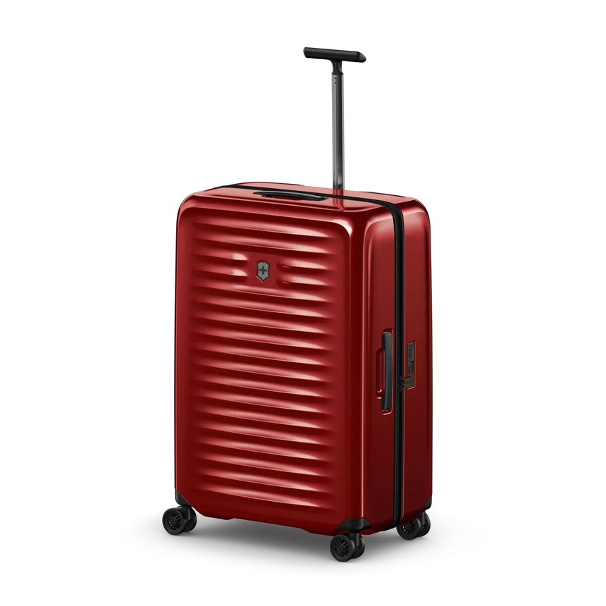 Red hardshell rolling suitcase with horizontal ridges and a retractable handle.