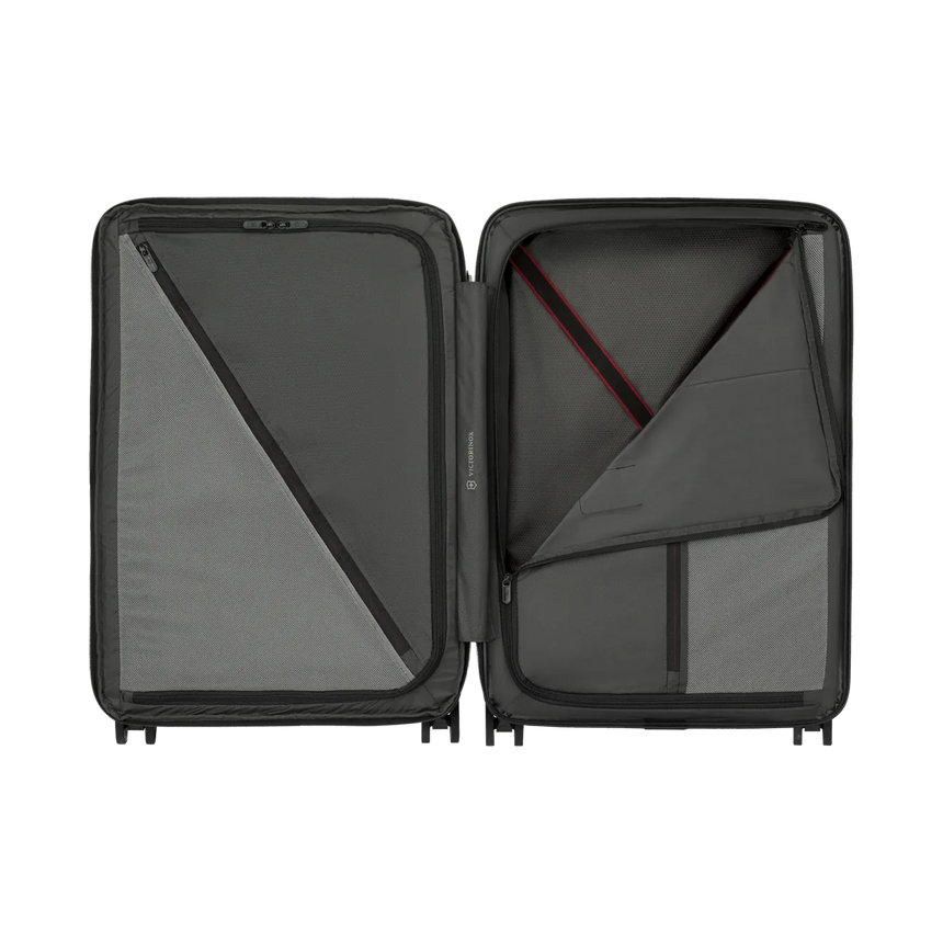 Open hard-shell suitcase with interior compartments and zippered sections.