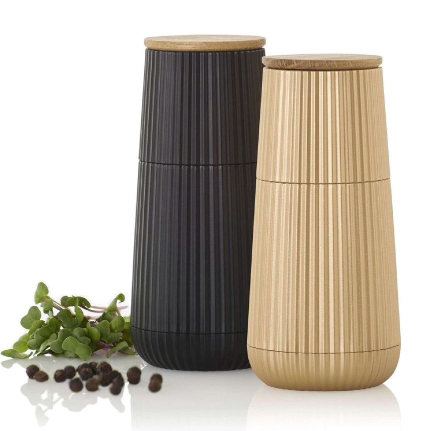 Pair of ribbed cylindrical containers with wooden lids in black and beige colors.
