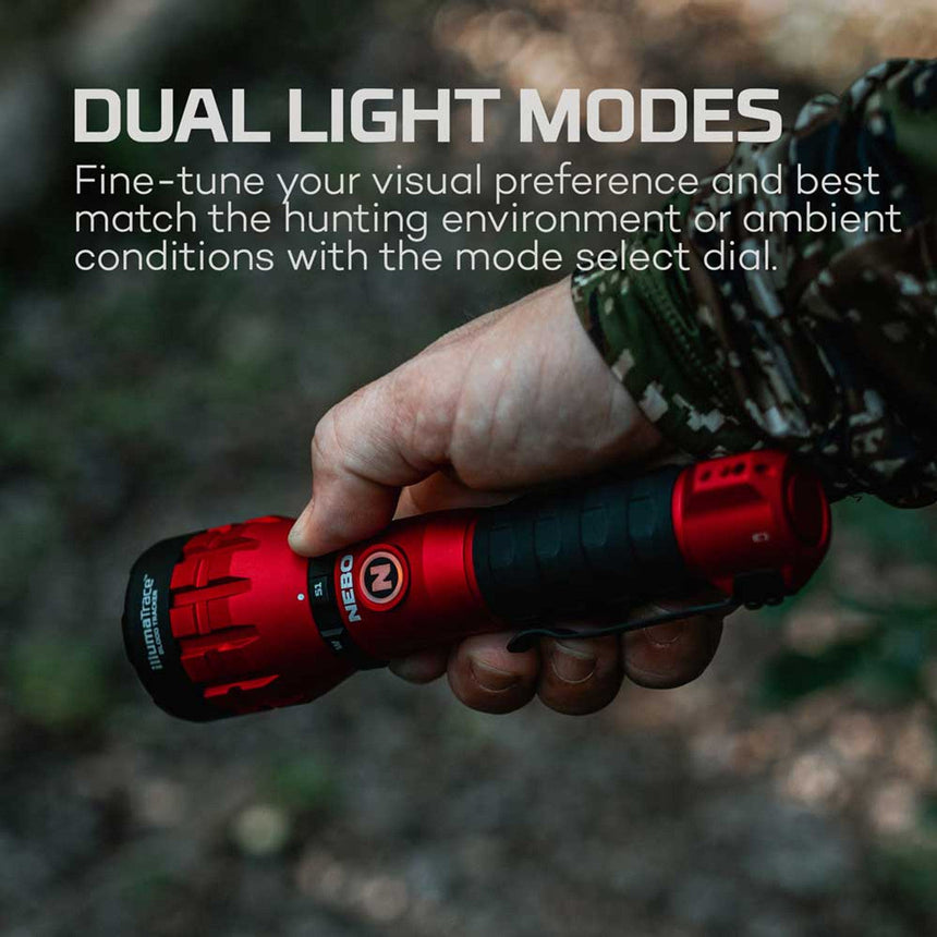 Red flashlight with dual light modes held in a hand wearing camouflage clothing.