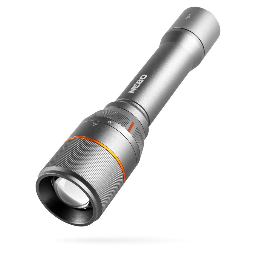 Silver metallic flashlight with adjustable focus and orange accent ring.