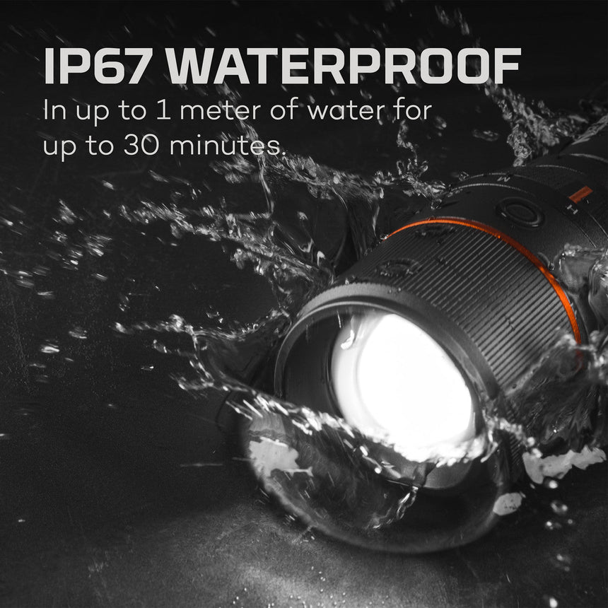 Waterproof light or flashlight submerged in water with splashes around it.