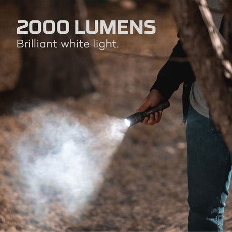 Handheld flashlight emitting an intense beam of white light.