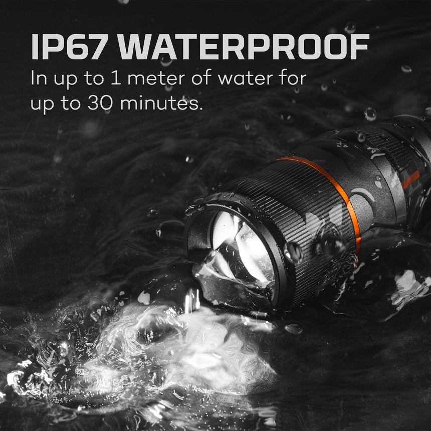 Waterproof flashlight submerged in water with bubbles surrounding it.