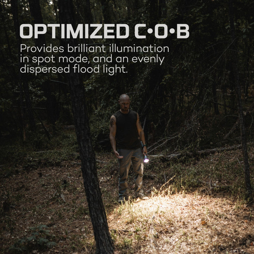 Flashlight demonstrating its illumination capabilities in a dark forest setting.