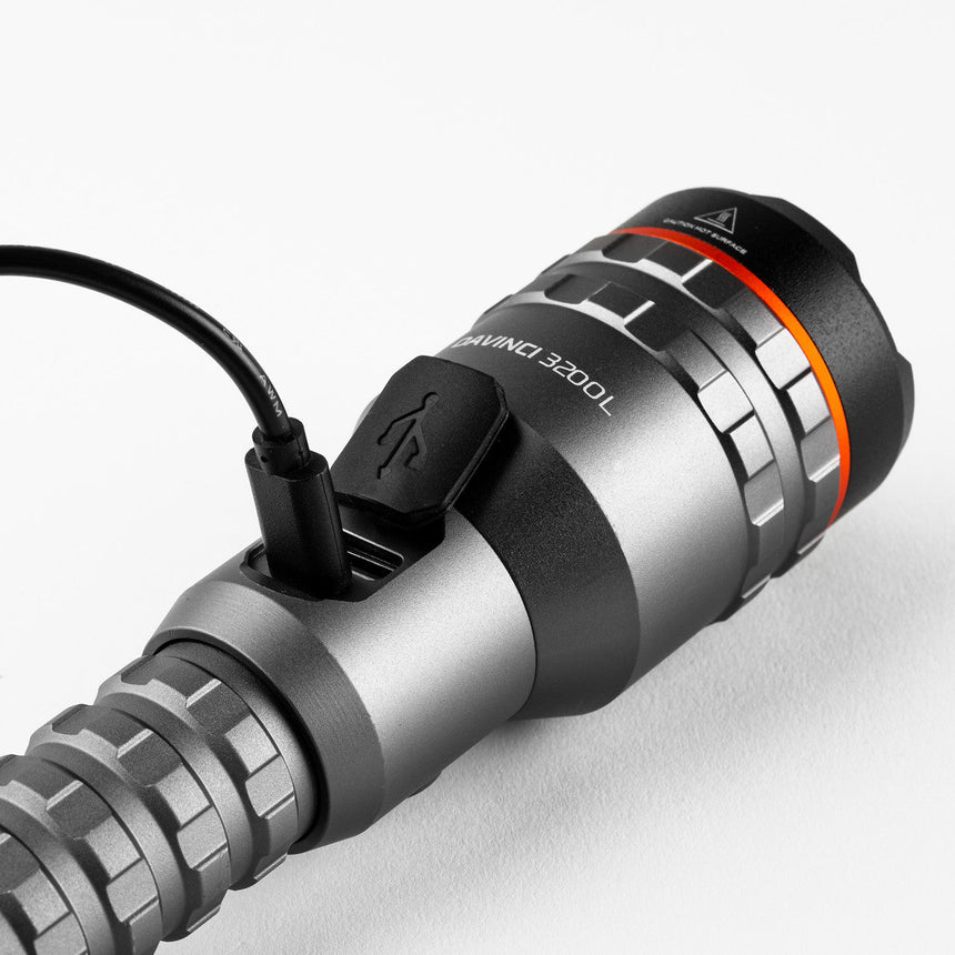 Sleek, cylindrical electronic device with adjustable rings and a USB cable attached.
