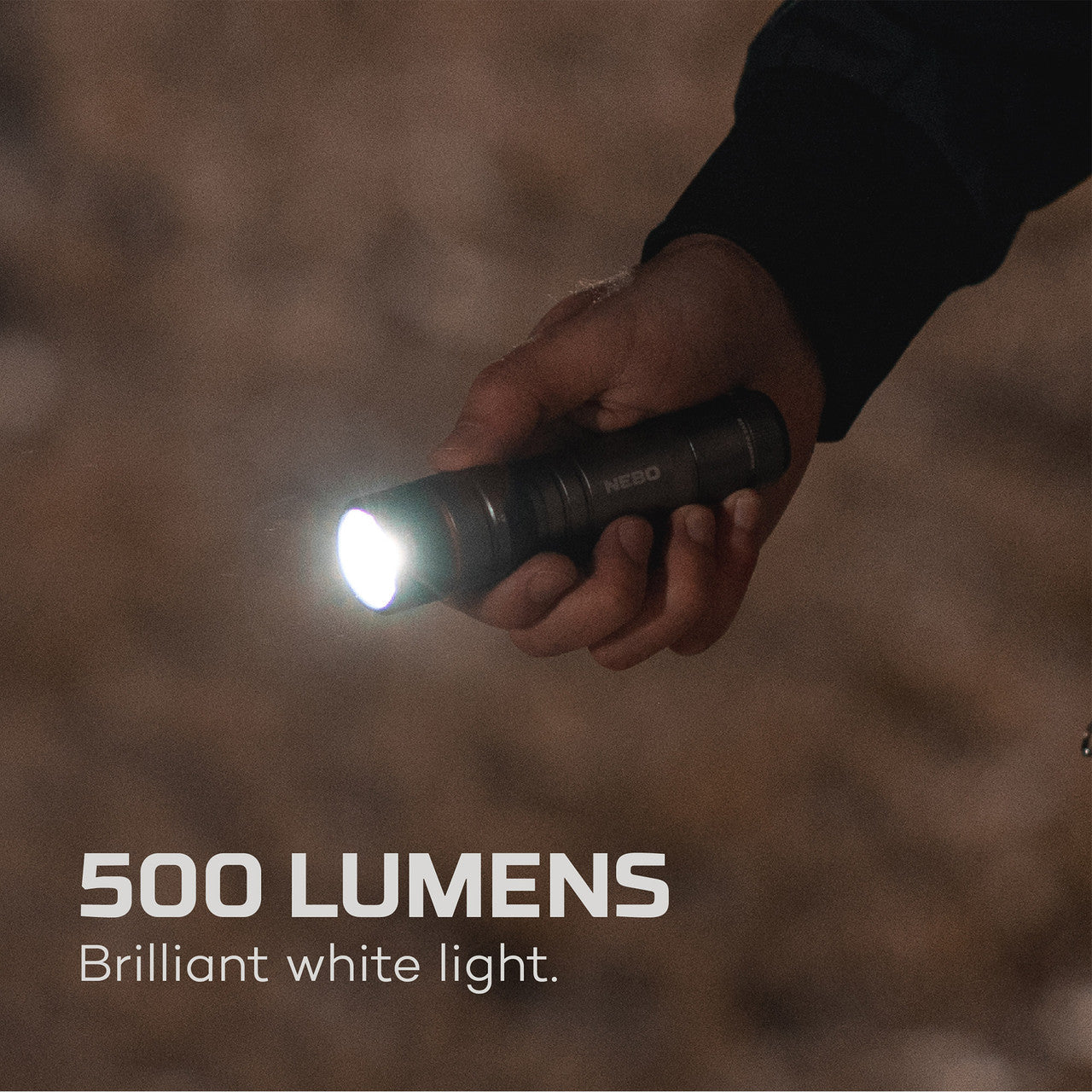 Handheld flashlight emitting a bright beam of light.