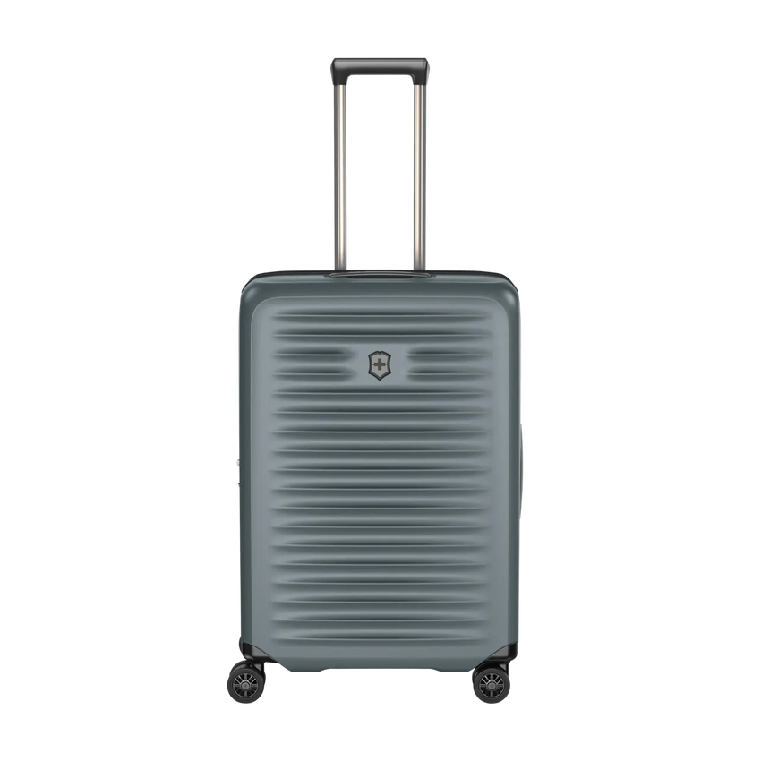 Gray hardshell rolling suitcase with horizontal ridges and an extendable handle.