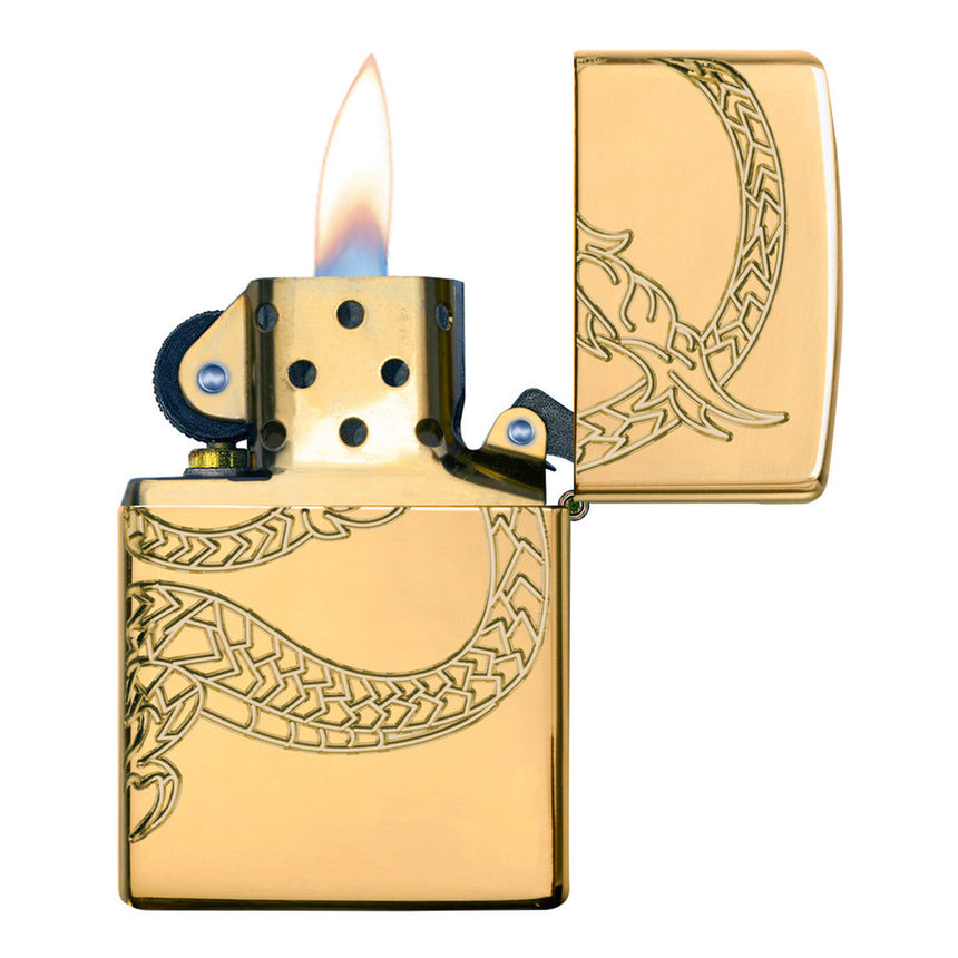 Gold-colored Zippo lighter with an engraved dragon design, shown lit.