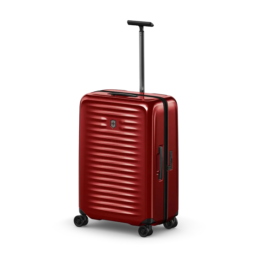 Red hardshell rolling suitcase with horizontal ridges and an extendable handle.