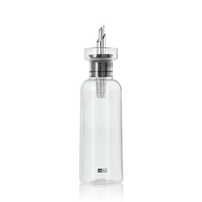 Glass bottle with a metal and plastic pouring spout or dispenser top.